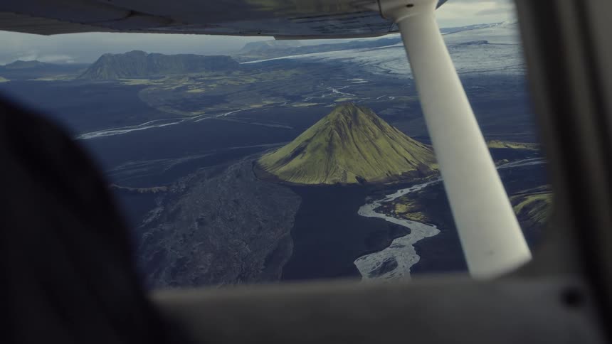 Mountainous region seen from an airplane in flight outdoors during day time