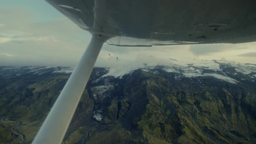 Aircraft flying on the air over a mountain range outdoors during day time