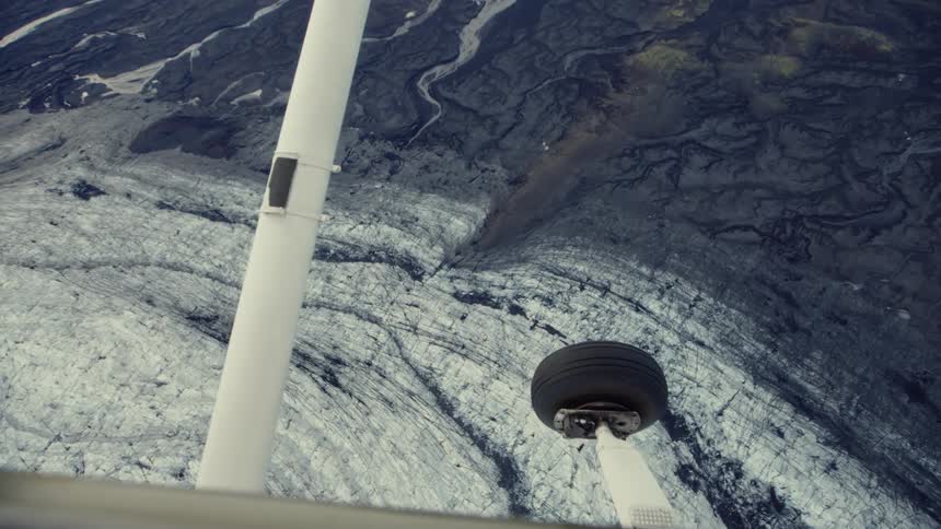 The plane is traveling over the mountain pass