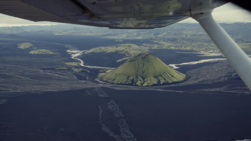 The plane wing flies high in the air