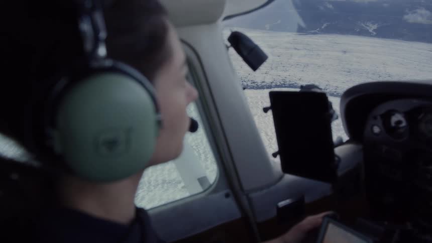 The woman is controlling the airplane