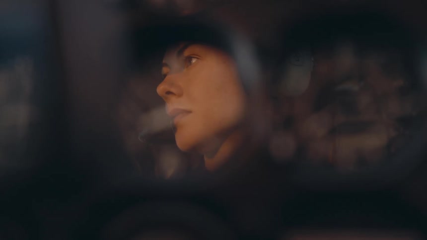 The reflection of a female pilot in a cockpit dial shifts into a close up of the airplanes flight instruments