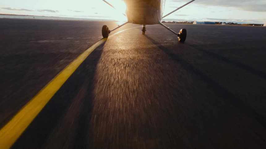 Small airplane rolling down the runway and taking off