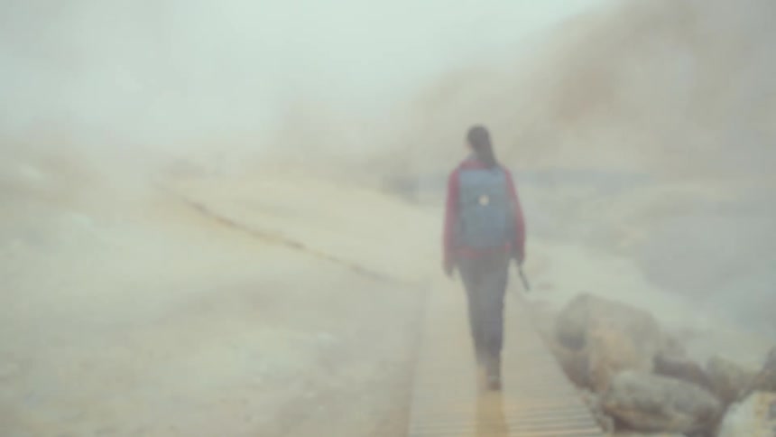 A woman walking in a canyon