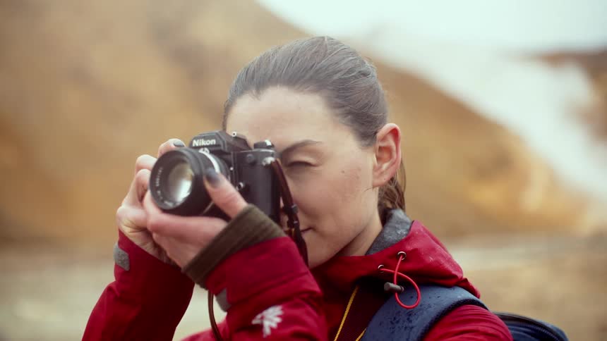 A woman taking a photo with a camera