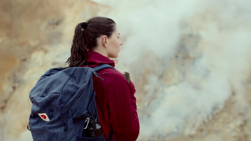 A woman outdoors with a backpack on