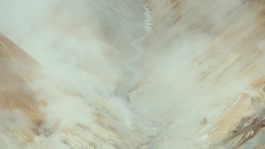 Rocky valley with steam rising amidst earthy hues