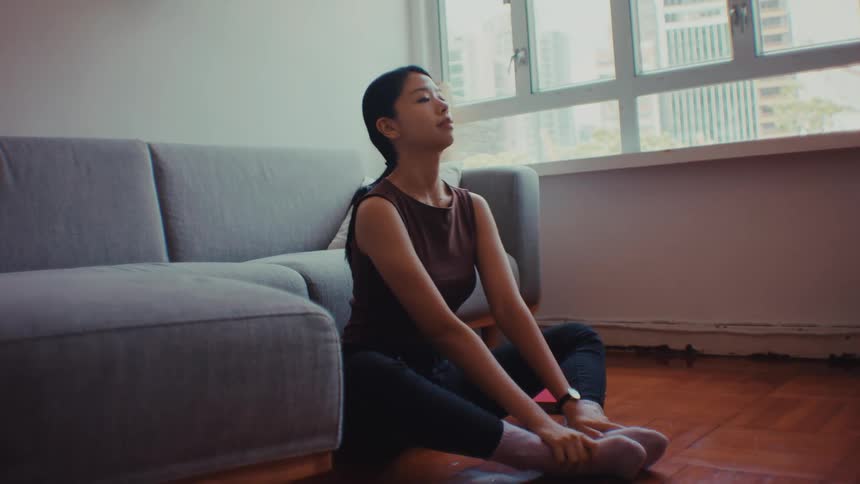 The woman is doing yoga at home