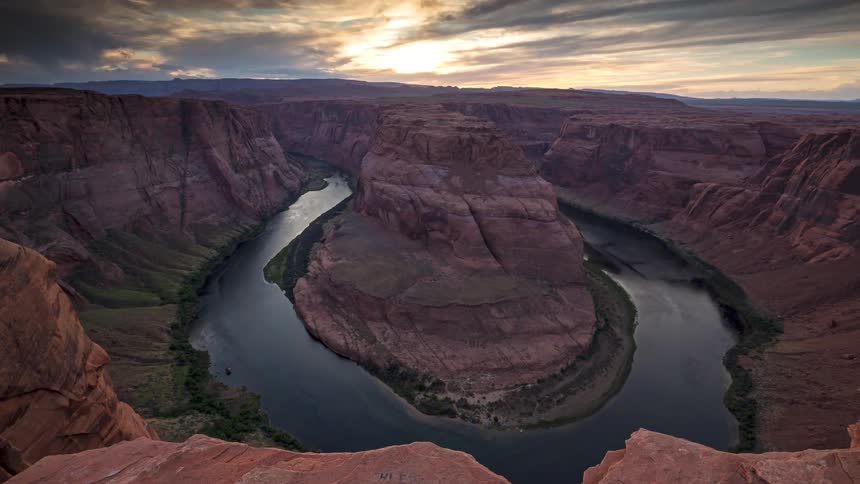 A time lapse of a river going around a rock