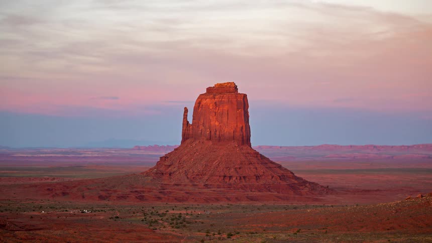 Butte and rock formations in the desert as shadows move over the land