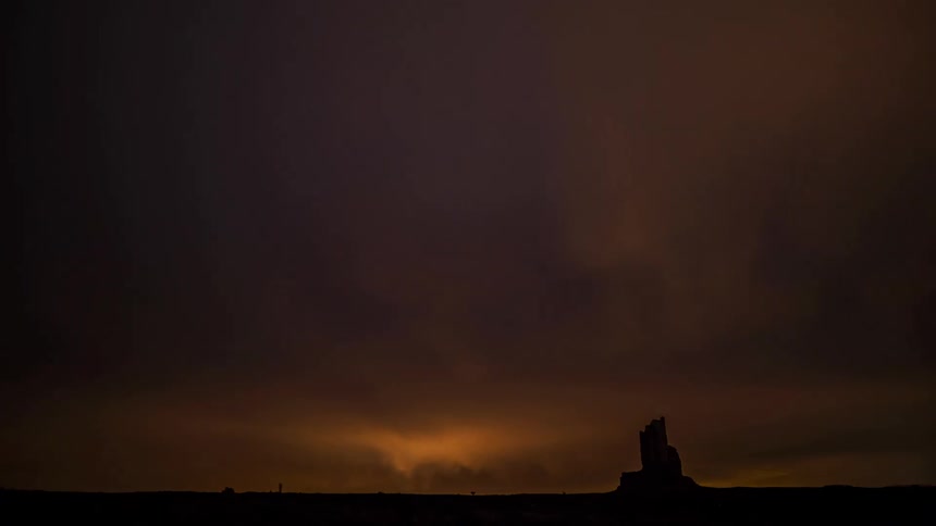 Clouds and stars fill the sky over the field