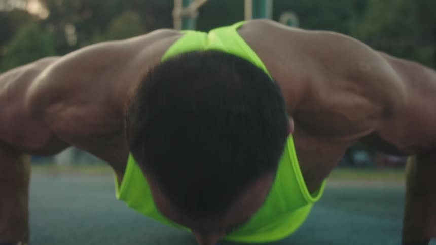 The man is doing pushups on a cloudy day