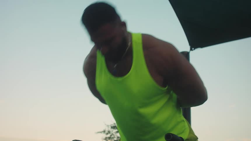 A man doing weight lifting outdoors
