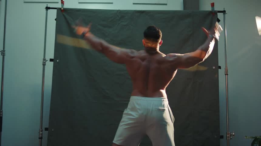 A view of a man stretching and flexing