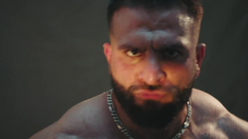 The strong man flexes his muscles