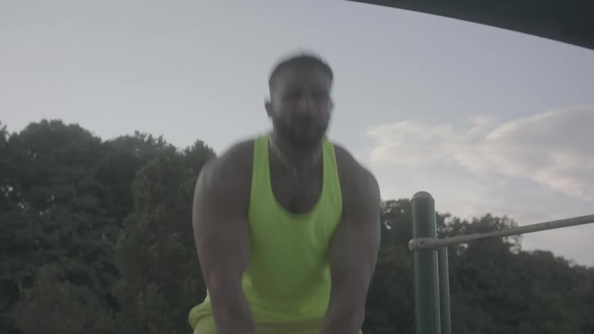 A man lifting weights outdoors