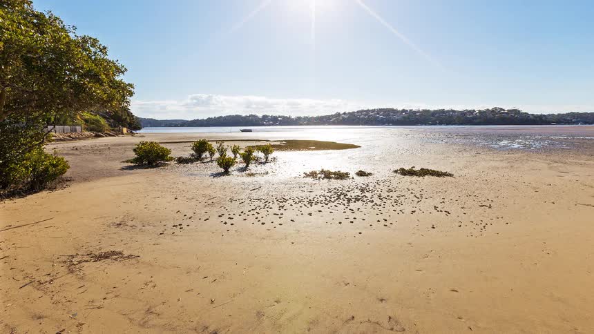 Exposed riverbed with receding water level and visible sandbanks
