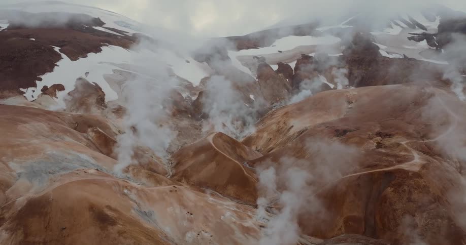 An aerial view of a mountain area with steam