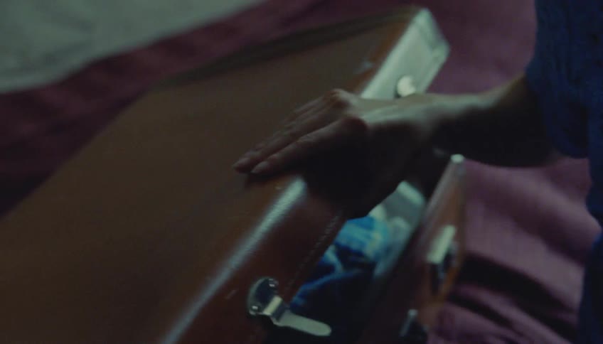 A woman packing a suitcase