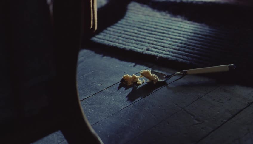 The spoon full of food bounces on the floor