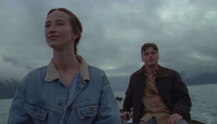 A man and woman in a boat on the water