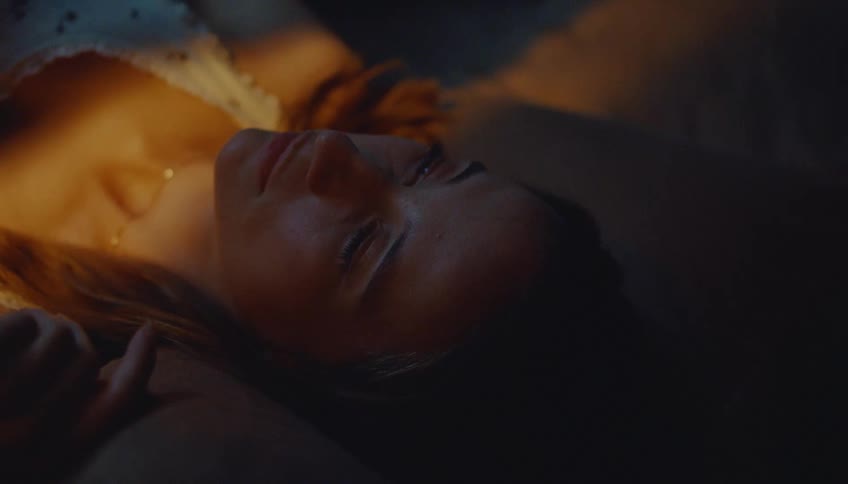 The woman is resting in bed