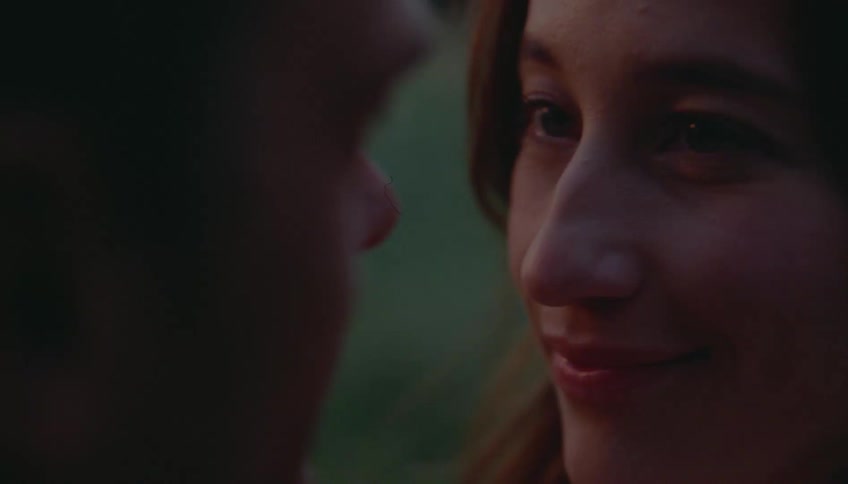 A romantic couple gazing into each others eyes sharing a tender moment at dusk