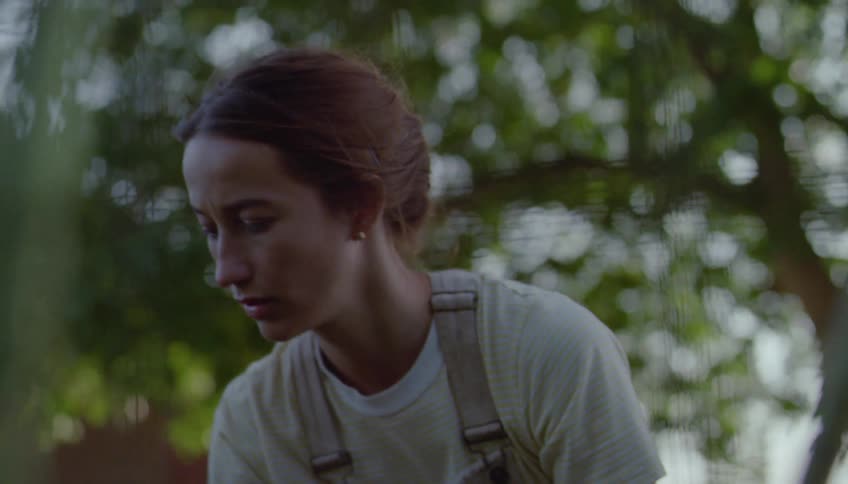 The woman is planting in her garden