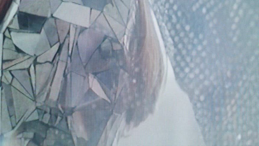 Closeup of a masked man in a fractured reflective mask performing slow eerie movements