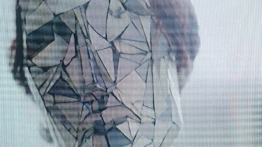 Closeup of a person wearing a faceted mirror mask performing slow eerie movements