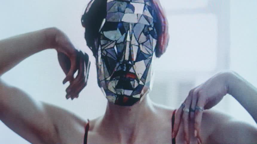 The woman wearing a reflective mask is stretching