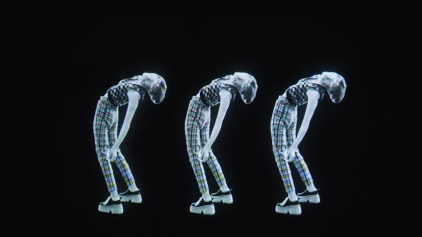 A woman is dancing and her image is tripled on the screen
