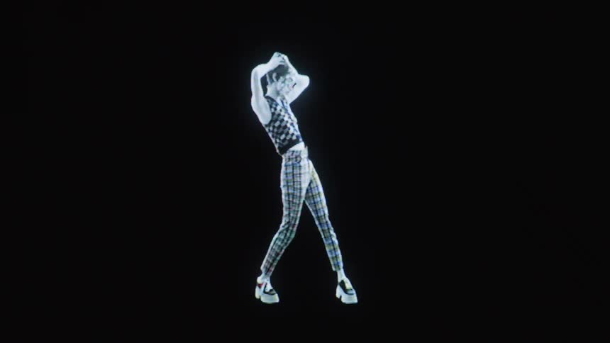 A masked woman with short hair wearing a checkered vest and plaid pants dances against a solid black background in a glowing blue and white artistic style