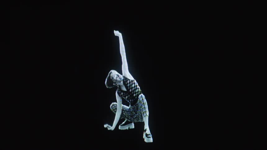 A person wearing a checkered vest and plaid pants performs expressive fluid movements against a stark black backgroundthe figure transitions from a crouched position to a full stretch highlighted by a glowing highcontrast visual effect