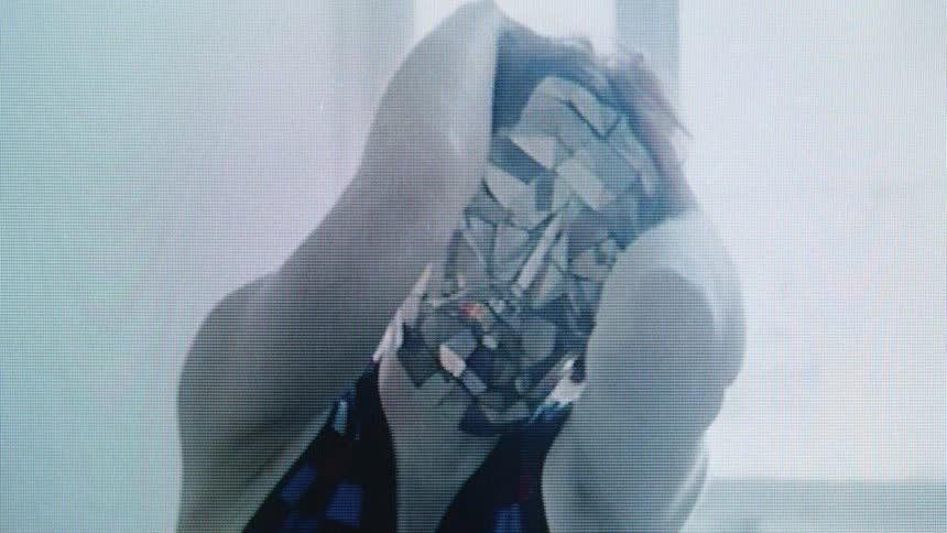 A woman modeling a mask in a room