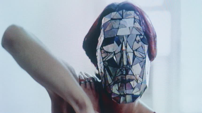Woman wears a geometric mask