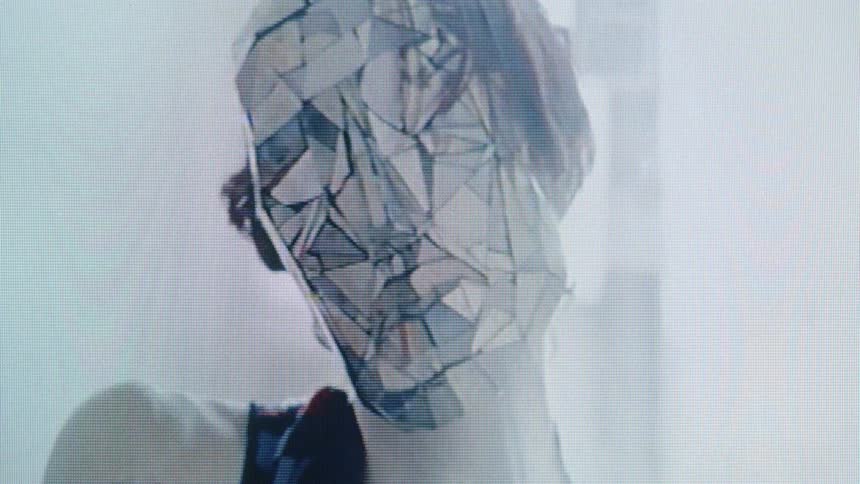 A virtual man wearing a mirror mask performing slow eerie hand gestures