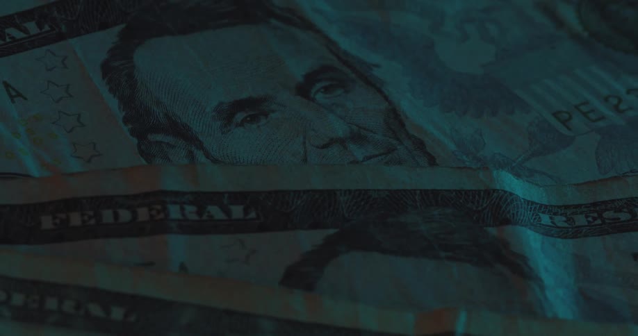 Closeup of a folded us five dollar bill highlighting abraham lincolns portrait
