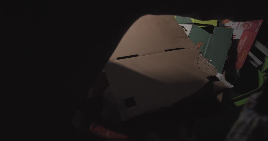 Cardboard being placed into a trash bin