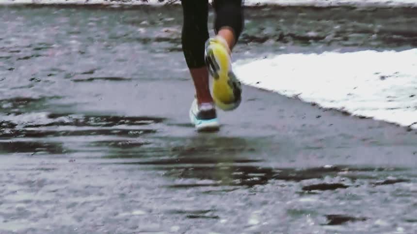 The person is running on the frozen pond