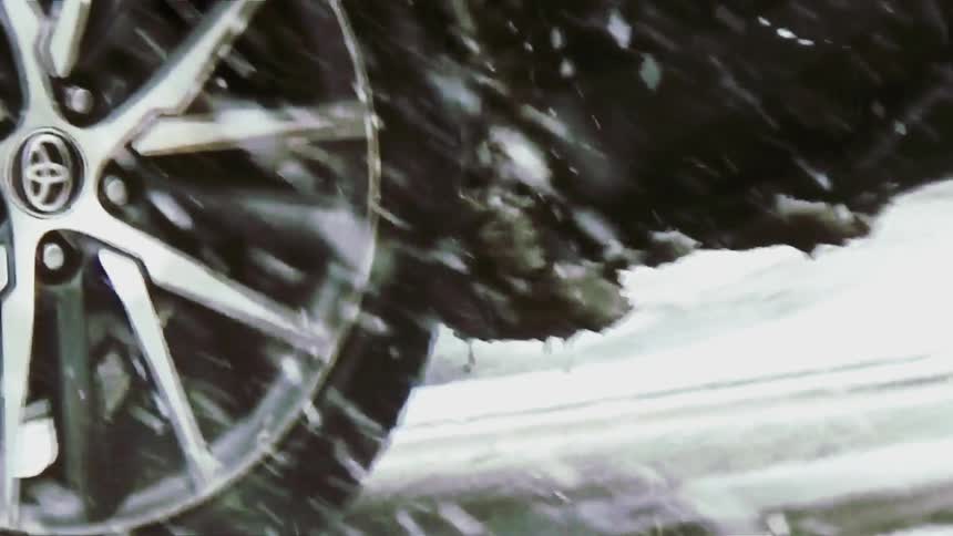 Car in motion passes through a snowstorm