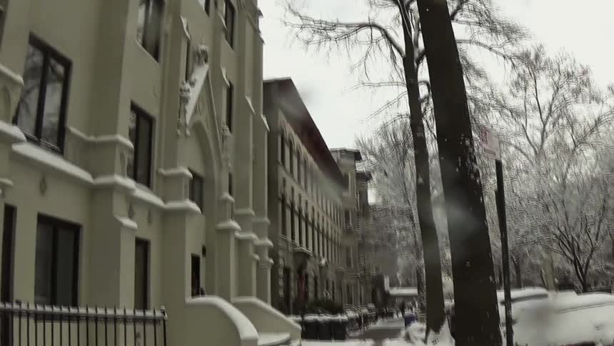 Residential sidewalk covered in snow with a cleared pedestrian path