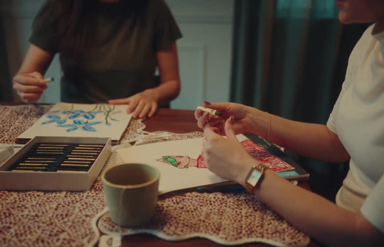 A man and woman coloring in a room