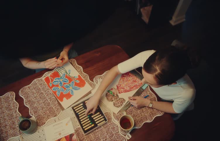 Two women sitting at a table coloring