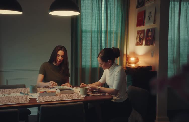 Two women talking and sitting at a table together