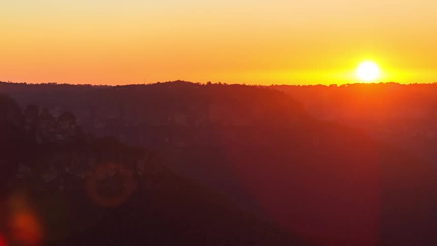 The sun is rising from behind the mountain