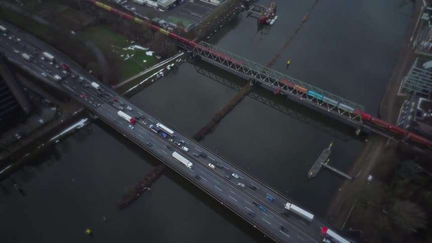 Vehicle traffic crossing bridges over a river seen from above