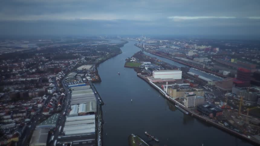 River running through an urban area with industrial and residential zones seen from high altitude