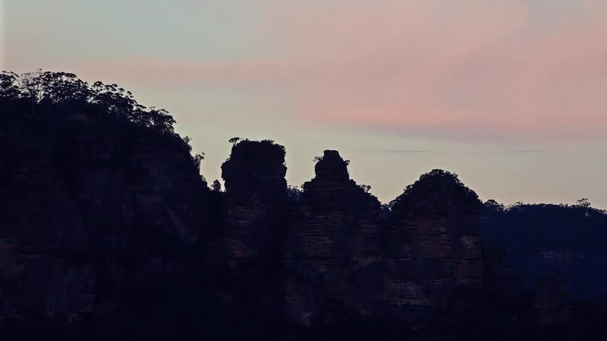 Rock formations in silhouette under an evening sky