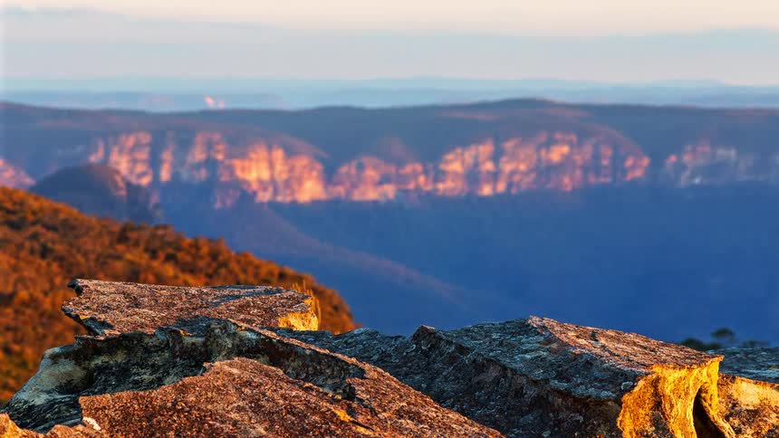 At sunset in the wilderness a mountainous peak with grassland below the mountain